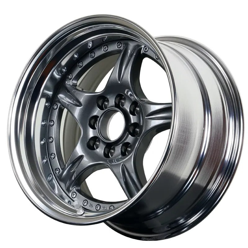 Close-up of a shiny alloy wheel on a white background