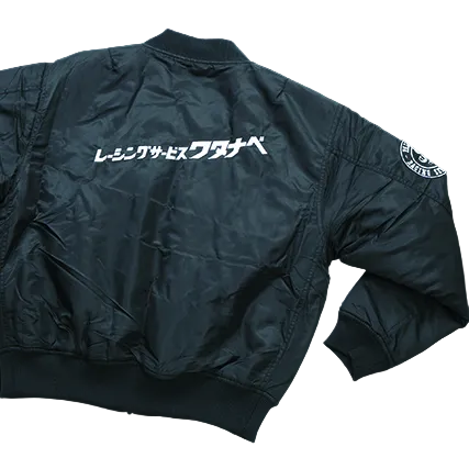 Dark blue bomber jacket with text on the back against a black background
