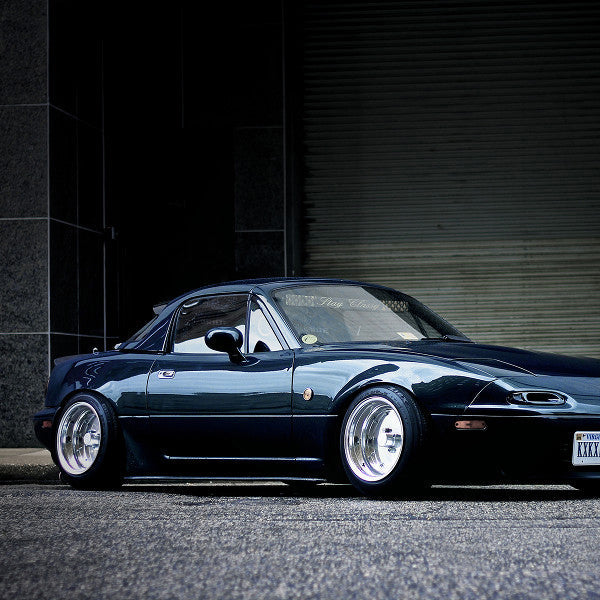 Black sports car parked in front of a dark wall with 'SSR' branding.