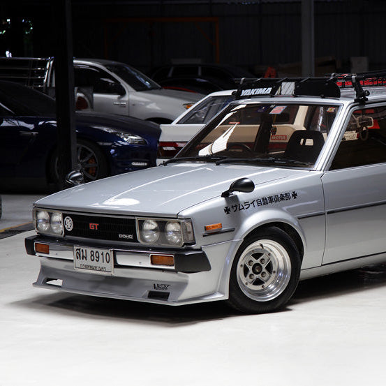 Silver station wagon with a visible license plate on a white background